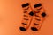 Orange socks with bats. Clothing costume for Halloween party. Cheerful bright multicolored sock top view