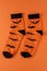 Orange socks with bats. Clothing costume for Halloween party. Cheerful bright multicolored sock top view