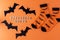 Orange socks with bats. Clothing costume for Halloween party. Cheerful bright multicolored sock top view.