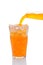 Orange Soda Pouring into Glass of Ice