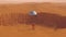 Orange Spaceman Spacewoman With Large Alien Silver Sphere Glowing Orange Crater Desert Sand Dune Landscape