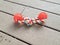 Orange spiky rubber and rope dog toy on wood