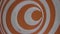 Orange spinning hypnotic wheel close up. Hypnosis Spirals