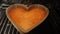 Orange sponge cake heart shaped baked in the oven. Valentines day. Time lapse. Close up