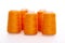 Orange spool of thread isolated on white background. Skein of woolen threads. Yarn for knitting. Materials for sewing