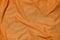 Orange sport clothing fabric texture background. Top view of orange cloth textile surface. Bright basketball shirt. Text Spac