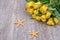 Orange starfishes and roses on a wooden background