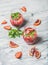 Orange and strawberry summer Sangria in glasses, marble background