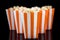 Orange striped box with popcorn, black background