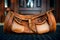 An orange stylish leather travel bag stands on a rubber mat at the entrance to a private home. Close-up, wide angle