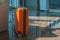 The orange suitcase is in the lobby of the hotel waiting for the owner. Luggage is made for travel