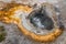 Orange sulfur ring around bubbling hot spring