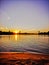 Orange Sundown over the sandy Beach of the river Rhein in Cologne with sky, Chappell and bridge landscape