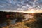 Orange sunny light with rays and shadows over the river at dawn