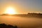 orange sunrise above low fog on the swamp valley with thÃ¼rer Wiesen