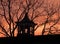 Orange Sunrise behind vintage historic wood barn louvered cupola