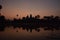 Orange sunrise over famous angkor wat temple with lake and reflection in the water with lillypad