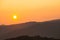 Orange sunset above serbian mountains with hills silhouette