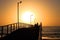 Orange Sunset behind Beach Jetty