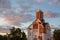 An orange sunset illuminates the Orthodox Church.