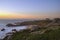 Orange sunset on a landscape with beach and chapel