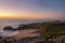 Orange sunset on a landscape with beach and church