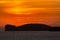 Orange sunset over Capo Caccia and lighthouse in Sardinia