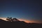 Orange sunset over the mountains with eucalyptus gum trees silhouettes shot in Tasmania