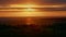 Orange sunset over the sea. Colorful rays of the sun and glare at the moment of sunset or dawn over the city near the