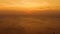 Orange sunset over the sea. The sun is setting over the horizon. Evening view of the mountains and sea. Big Cumulus clouds in the
