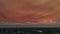 Orange sunset and silhouettes of coastal buildings on the coast of Naples in Florida. Wide aerial view