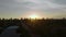 Orange sunset and silhouettes of coastal high-rise buildings on the coast of Naples in Florida. Wide aerial shot