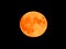 Orange super moon on a black sky