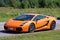 Orange supercar on a racetrack