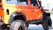 Orange SUV. Oversized off-road wheel tread