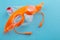 Orange swim goggles lie on a plastic case, look like a small animal, concept of aquatic sports and active lifestyle