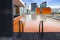 Orange swimming pool on rooftop with modern buildi