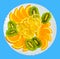 Orange, tangerine and kiwi on a plate on a blue insulated background. Citrus to the festive table, isolate_