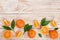 Orange or tangerine with leaves on white wooden background. Flat lay, top view. Fruit composition