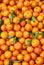 Orange tangerines with leaves lie on a counter in a store top view. Mandarins in the market