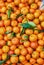 Orange tangerines with leaves lie on a counter in a store top view. Mandarins in the market