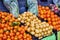 Orange tangerines with leaves and pears  lie on a counter in a fruit store top view. Mandarins in the market