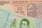 A orange ten rupee bill from India paired with a green twenty baht bank note from Thailand.