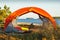 Orange tent on the island close-up. The tent in focus, background is blurred. The concept of adventure