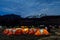 Orange tents illuminated before Mount Kilimanjaro during night