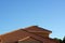 Orange terra cotta rooftop against blue sky