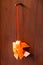 Orange thai traditional woven ribbon mobile gold fish hanging on wooden door