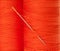 Orange thread with needle