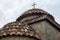 Orange tile roof with gold cross on Greek Orthodox church close up