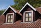 Orange tiled roof and garret windows in old house